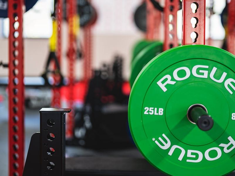 Atmospheric shot of a weight bench in a neon gym.