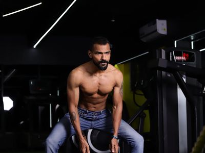 Blurred motion of a person training with ropes.